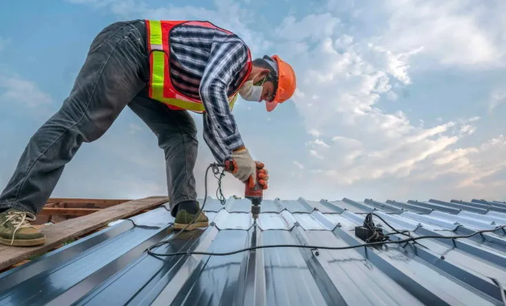 Crew installing metal roof panels (sample photo)